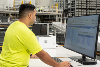 Man in warehouse using a computer